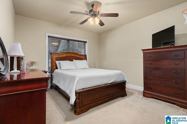 bedroom featuring ceiling fan and light carpet