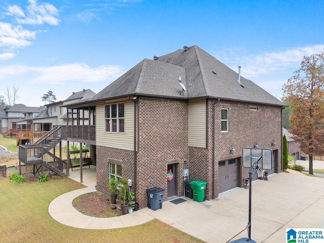 view of side of home with a garage and a sunroom