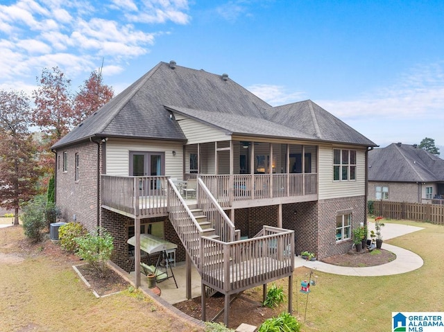 back of property featuring french doors, a yard, central AC unit, a deck, and a patio