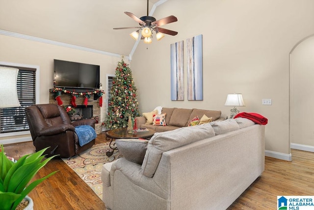 living room featuring ceiling fan, light hardwood / wood-style flooring, and crown molding