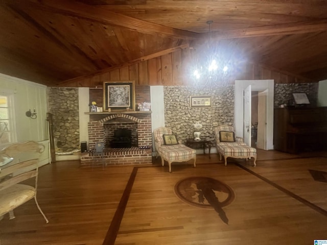 unfurnished room with a fireplace, hardwood / wood-style floors, vaulted ceiling with beams, and wood ceiling