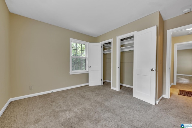 unfurnished bedroom with light colored carpet