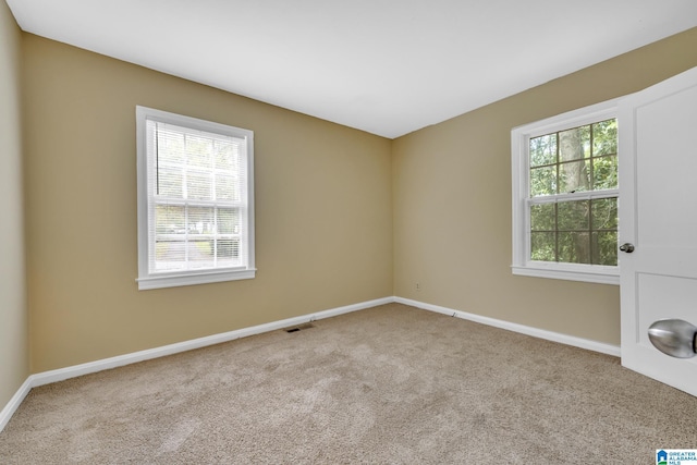 unfurnished room with light colored carpet