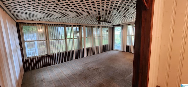 unfurnished sunroom featuring ceiling fan