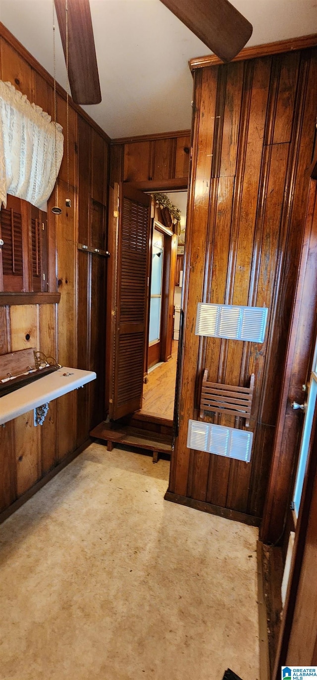 bathroom featuring wooden walls