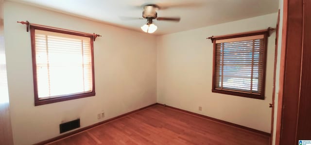 empty room featuring wood-type flooring and ceiling fan