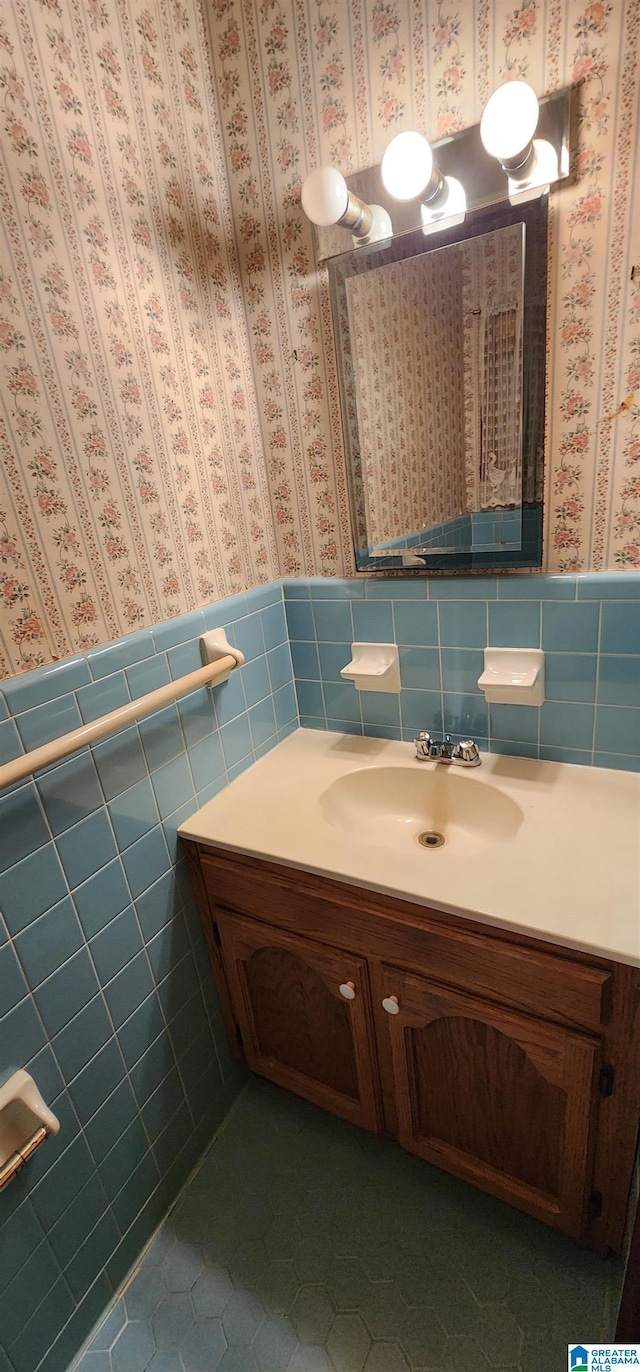 bathroom with vanity, tile patterned floors, and tile walls