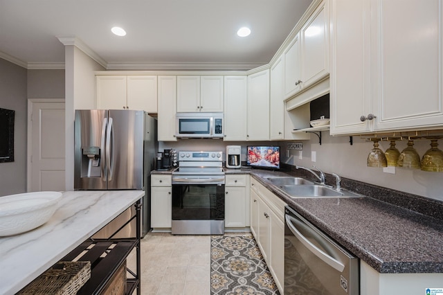 kitchen featuring stainless steel appliances, white cabinetry, crown molding, and sink