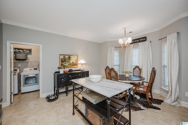 dining space featuring a chandelier, light tile patterned floors, washer and clothes dryer, and crown molding