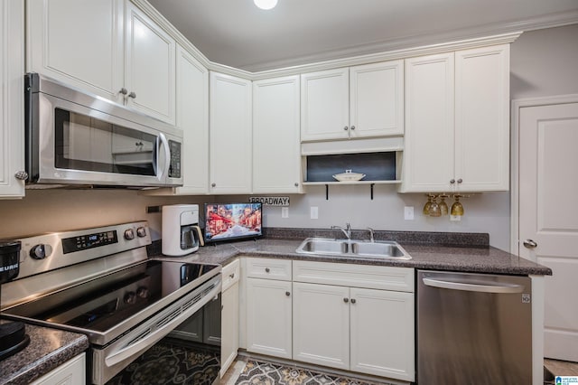 kitchen featuring white cabinets, appliances with stainless steel finishes, and sink