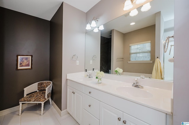 bathroom featuring tile patterned flooring, vanity, and a bathtub