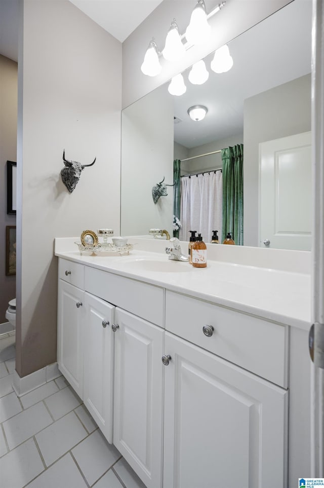 bathroom with a shower with curtain, tile patterned flooring, vanity, and toilet