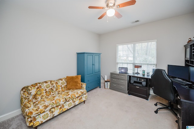 carpeted home office with ceiling fan