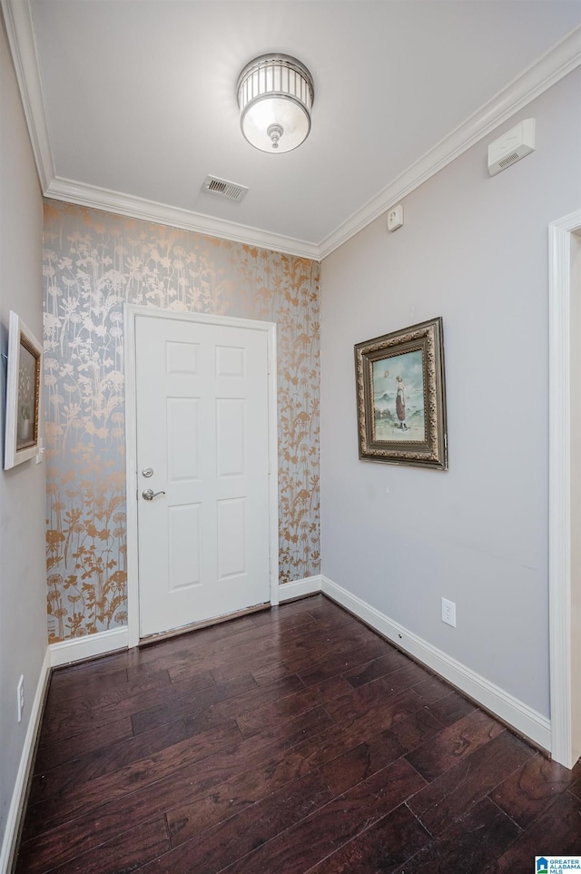 spare room featuring ornamental molding and dark wood-type flooring