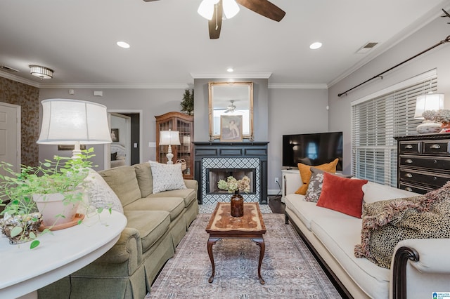 living room with ceiling fan, a fireplace, hardwood / wood-style floors, and ornamental molding