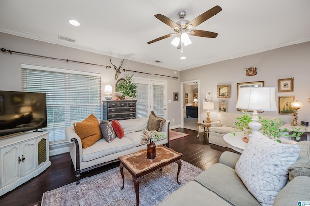 living room with crown molding, dark hardwood / wood-style flooring, and ceiling fan