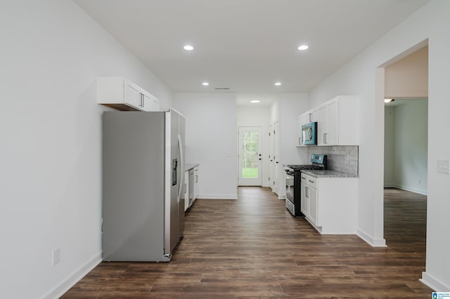kitchen featuring white cabinetry, appliances with stainless steel finishes, recessed lighting, and dark wood finished floors