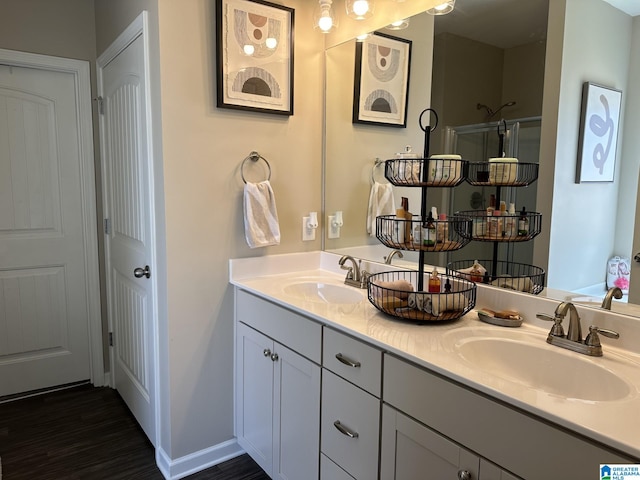 bathroom featuring vanity, hardwood / wood-style flooring, and a shower with door