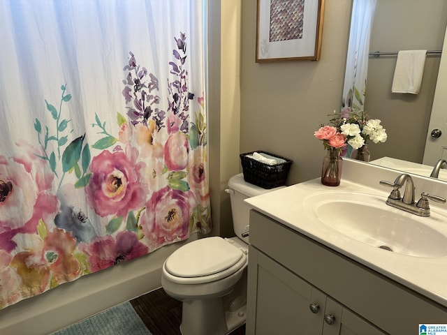 full bathroom featuring vanity, shower / bath combo, and toilet