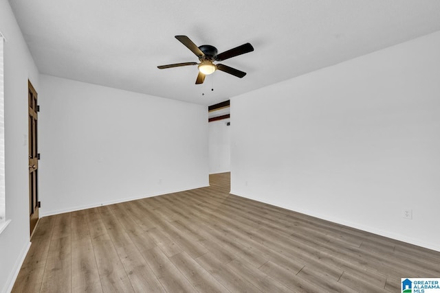 empty room featuring light hardwood / wood-style flooring and ceiling fan