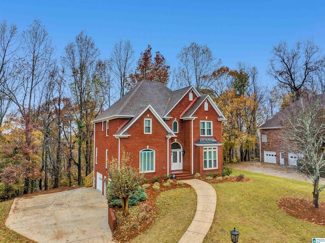 front facade featuring a front lawn and a garage