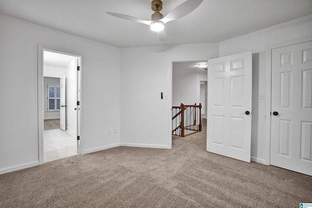 unfurnished bedroom featuring light carpet and ceiling fan