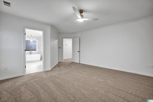 carpeted empty room with ceiling fan and crown molding