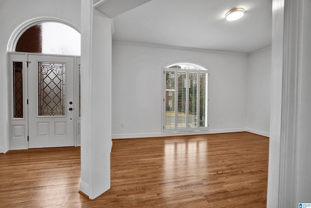 foyer entrance featuring light wood-type flooring and ornamental molding