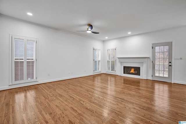 unfurnished living room featuring a wealth of natural light and hardwood / wood-style floors