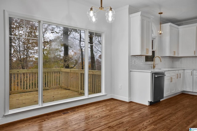 kitchen with a chandelier, white cabinetry, hanging light fixtures, and ornamental molding