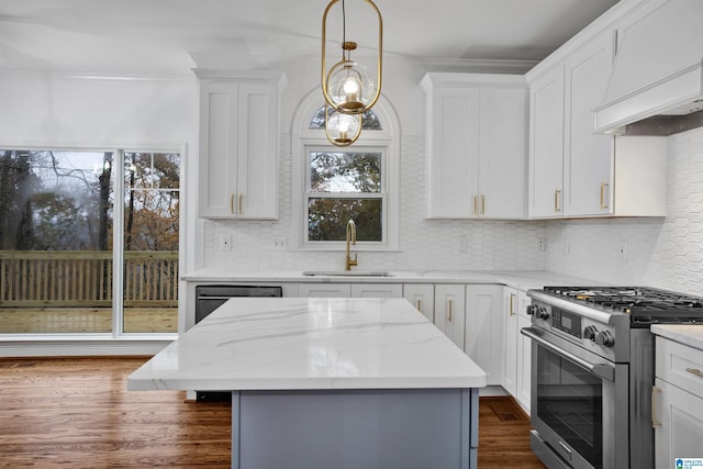 kitchen with appliances with stainless steel finishes, white cabinetry, and sink