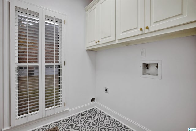 washroom with electric dryer hookup, cabinets, and hookup for a washing machine