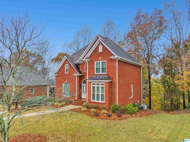 front of property with a front lawn and cooling unit