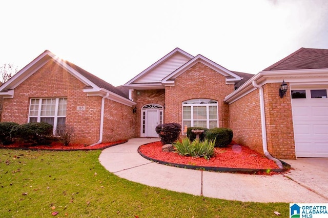 view of front of property with a garage and a front yard