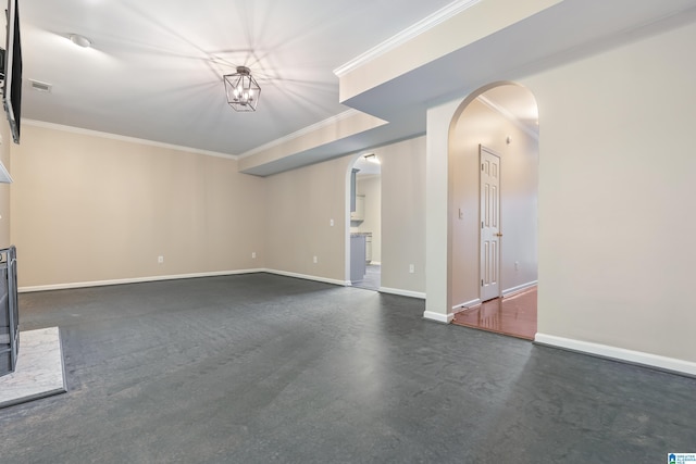 unfurnished living room with crown molding and an inviting chandelier