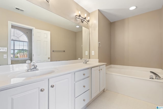 bathroom featuring vanity and a tub