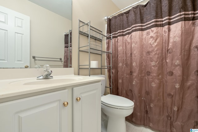 bathroom with tile patterned floors, vanity, and toilet