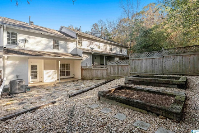 rear view of property featuring a patio area and central air condition unit