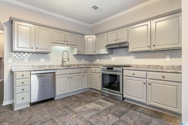 kitchen with light stone countertops, backsplash, ornamental molding, stainless steel appliances, and sink