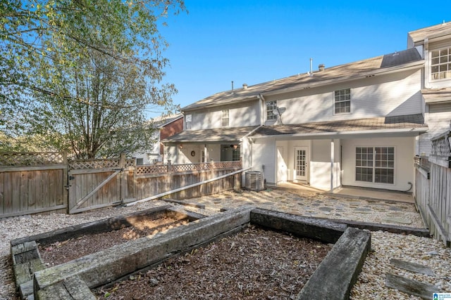 rear view of house with a patio and central air condition unit