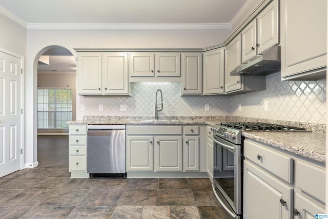 kitchen featuring crown molding, sink, light stone countertops, tasteful backsplash, and stainless steel appliances