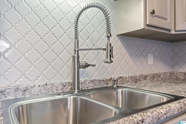 interior details with decorative backsplash and sink