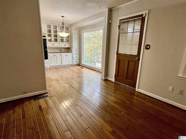 interior space with hardwood / wood-style floors and a textured ceiling