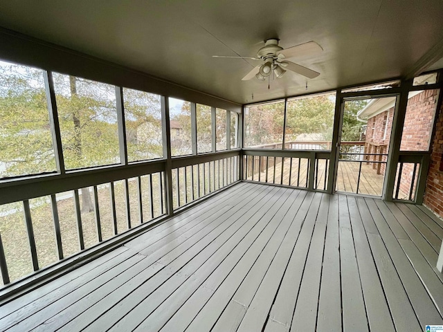 unfurnished sunroom with a wealth of natural light and ceiling fan