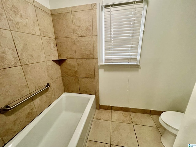 bathroom with tile patterned flooring, toilet, and a tub