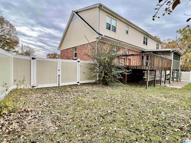 rear view of property featuring a patio and a deck