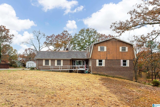 view of front facade featuring a front yard and a storage unit