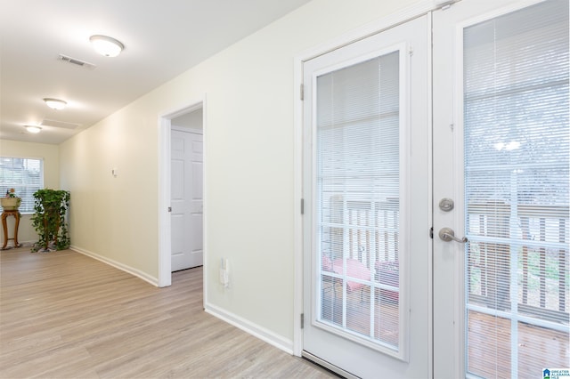 interior space with french doors and light hardwood / wood-style floors