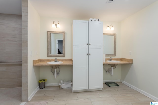 bathroom featuring tile patterned flooring and sink