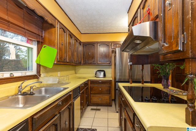 kitchen featuring black electric stovetop, a textured ceiling, sink, exhaust hood, and light tile patterned floors